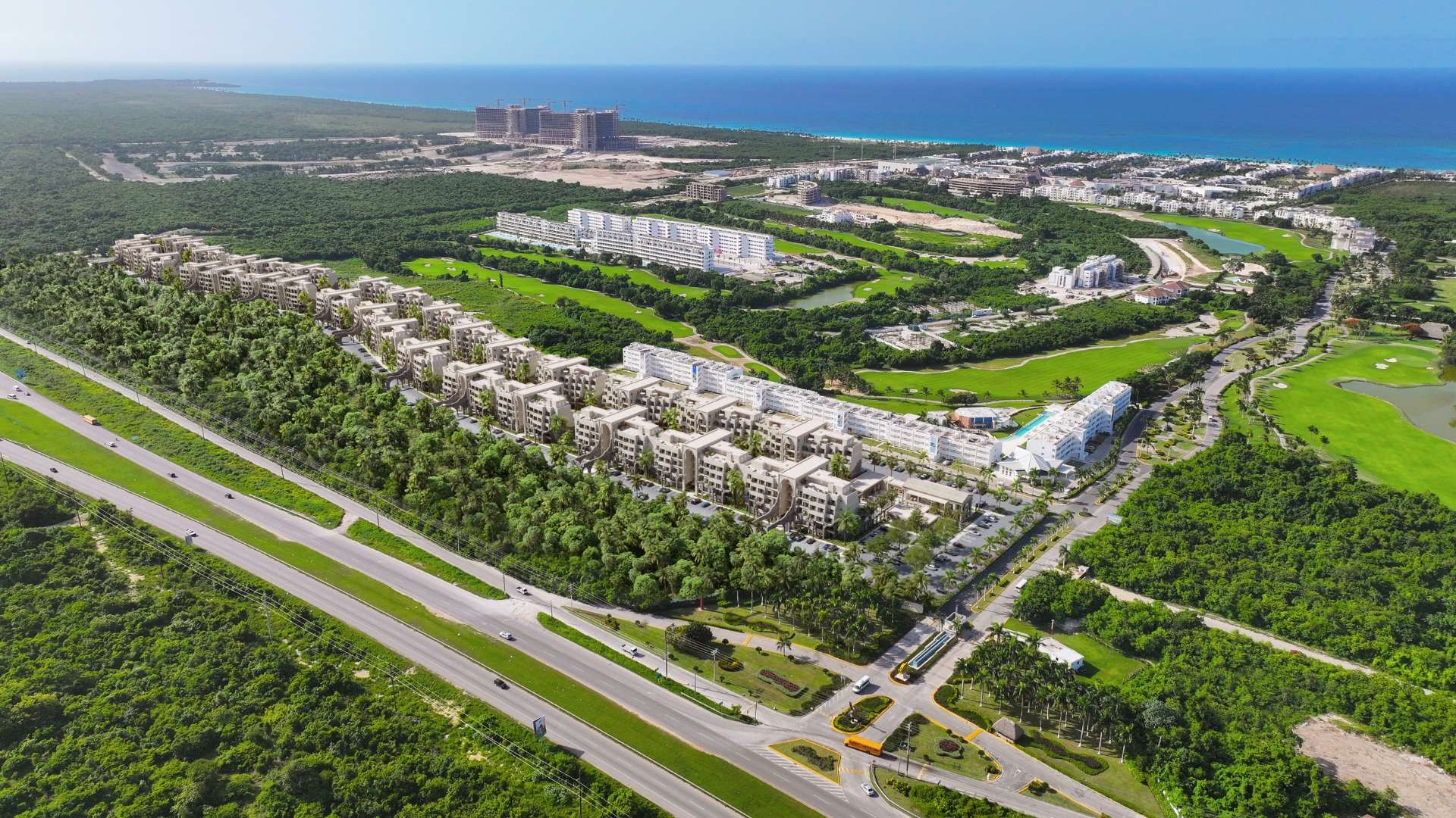 Aerial rendering of the Poseidonia masterplan in Cana Bay: 1,319 residences between the golf fairways and the ocean, about 5 minutes from Arena Gorda Beach.