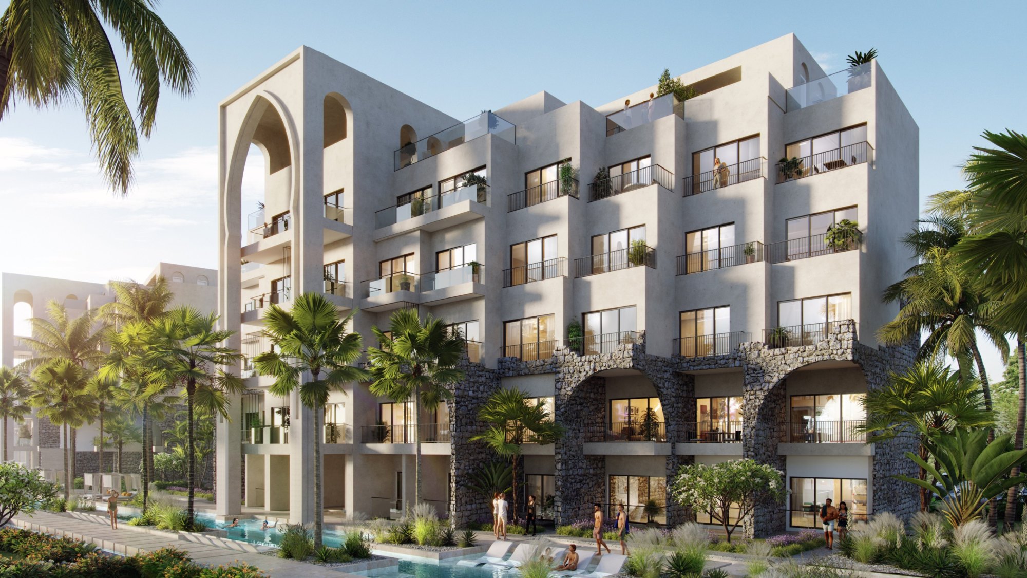 Rendering of a residential block at Poseidonia in gated Cana Bay, its arched portal and stone arcade at street level; one of 1,319 residences due in 2028.